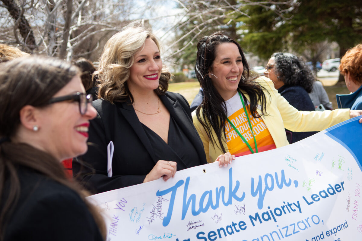 Senate Majority Leader Nicole Cannizzaro (D-Las Vegas), center, poses for a photos with Nevada Advocates for Planned Parenthood Affiliates Executive Director Lindsey Harmon, right, and NARAL Pro-Choice America Southwest Regional Director Caroline Mello Roberson, left, after a press conference outside the Legislature ahead of a hearing for SJR 7 on March 23, 2023 in Carson City. (David Calvert/The Nevada Independent)