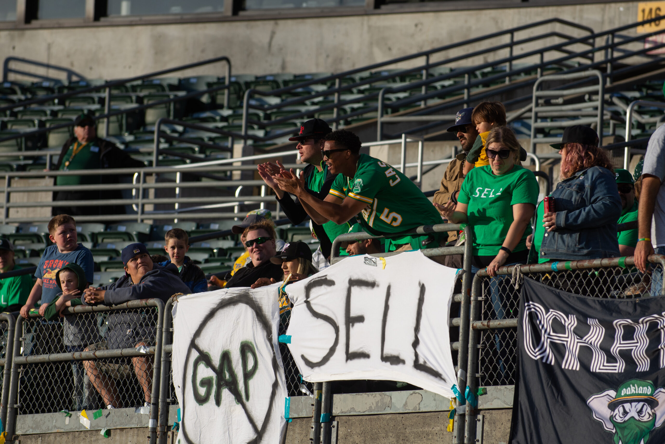 Oakland Athletics fans hold signs protesting the team's ownership during a game at the Oakland Coliseum in Oakland, Calif., on Friday, May 12, 2023. (David Calvert/The Nevada Independent).