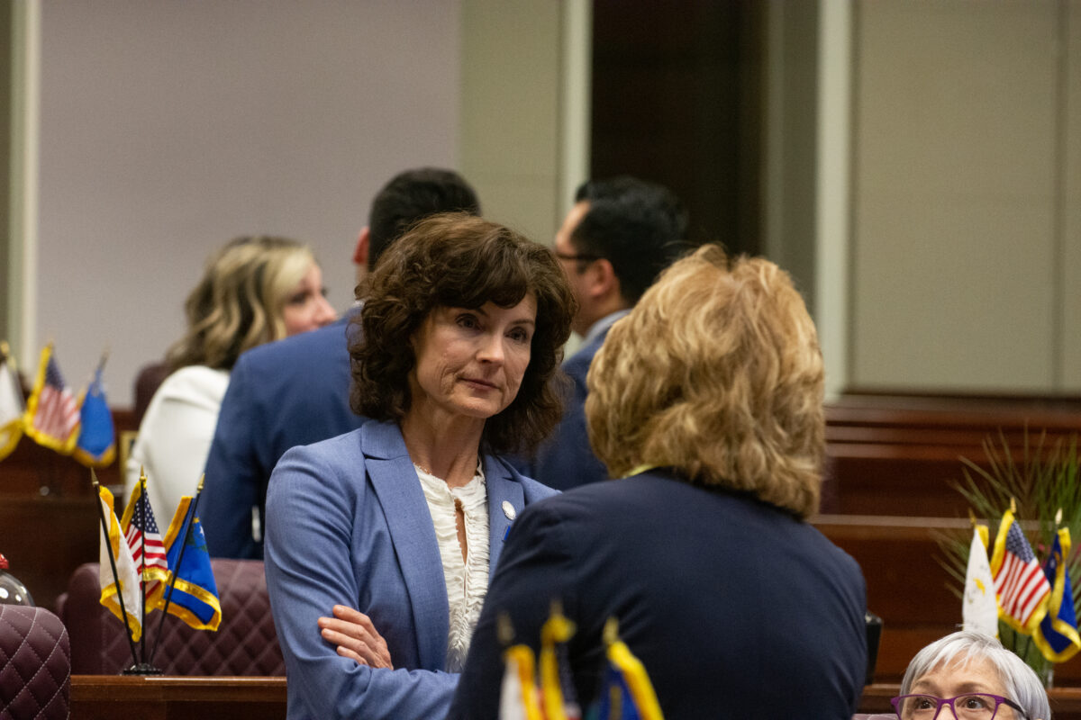 Senate Minority Leader Heidi Seevers Gansert (R-Reno) speaks with Sen. Marilyn Dondero Loop (D-Las Vegas) on the Senate floor after the Senate adjourned sine die for the 82nd legislative session in Carson City on June 6, 2023. (David Calvert/The Nevada Independent).