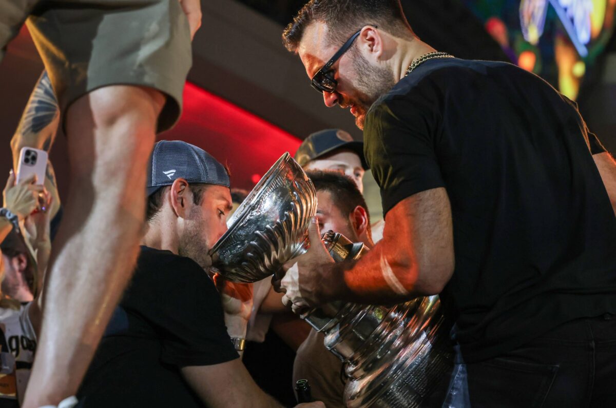 Vegas Golden Knights players drink out of the Stanley Cup during a party in front of T-Mobile Arena on Saturday, June 17, 2023. (Jeff Scheid/The Nevada Independent).