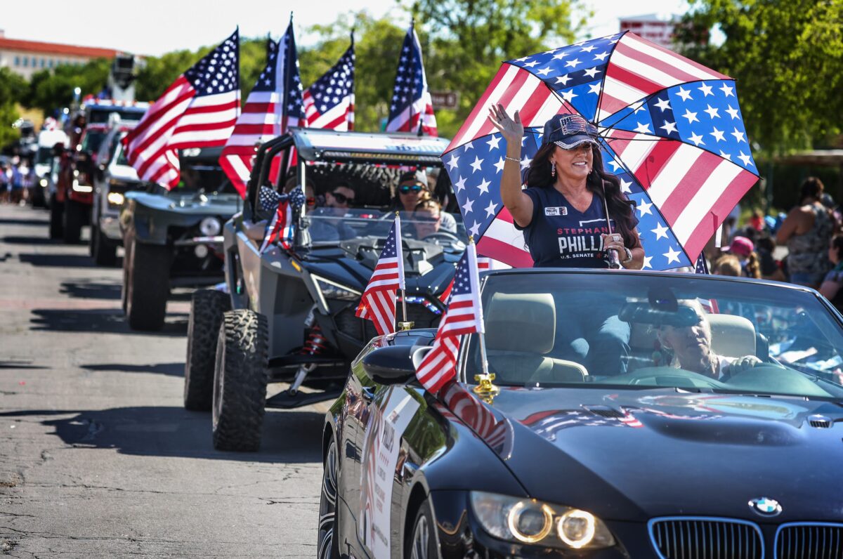 Stephanie Phillips, Republican candidate for U.S. Senate, waves during the 75th annual Damboree parade in Boulder City on Tuesday, July 4, 2023. (Jeff Scheid/The Nevada Independent)
