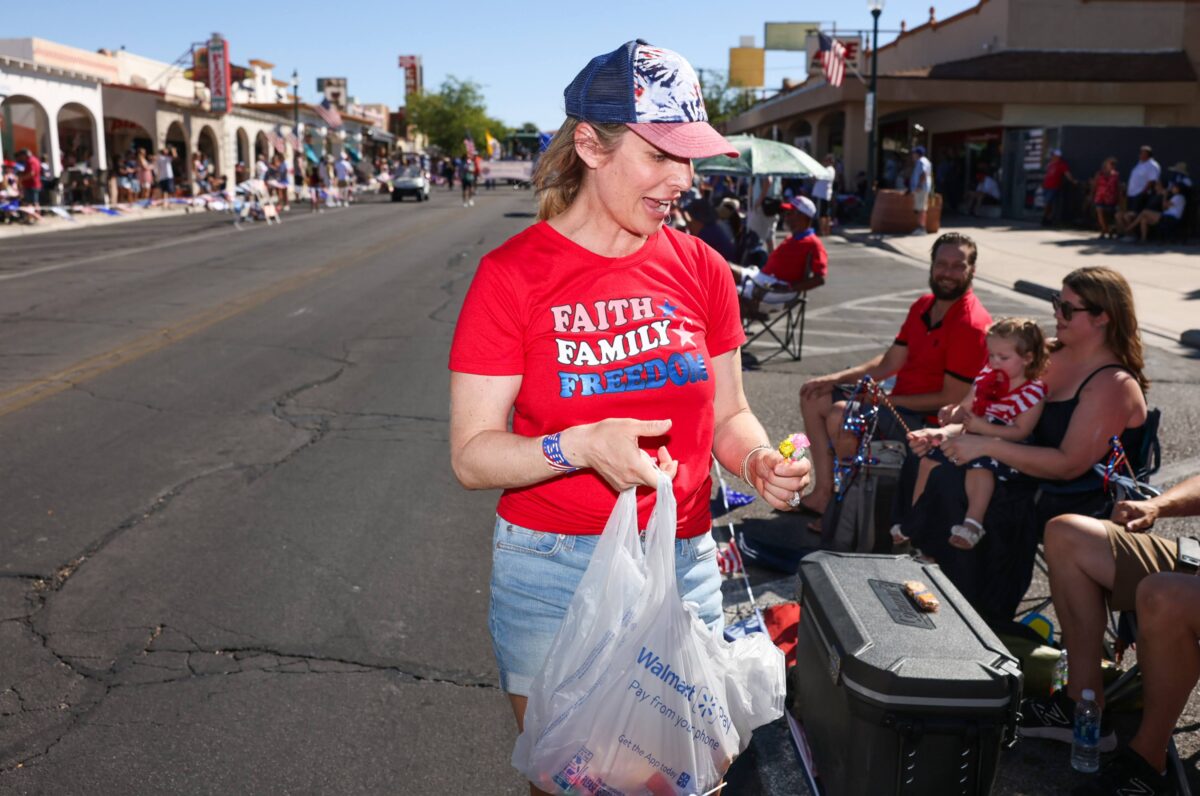 Assemblywoman Danielle Gallant (R-Las Vegas) hands out candy during the 75th annual Damboree parade in Boulder City on Tuesday, July 4, 2023. (Jeff Scheid/The Nevada Independent)
