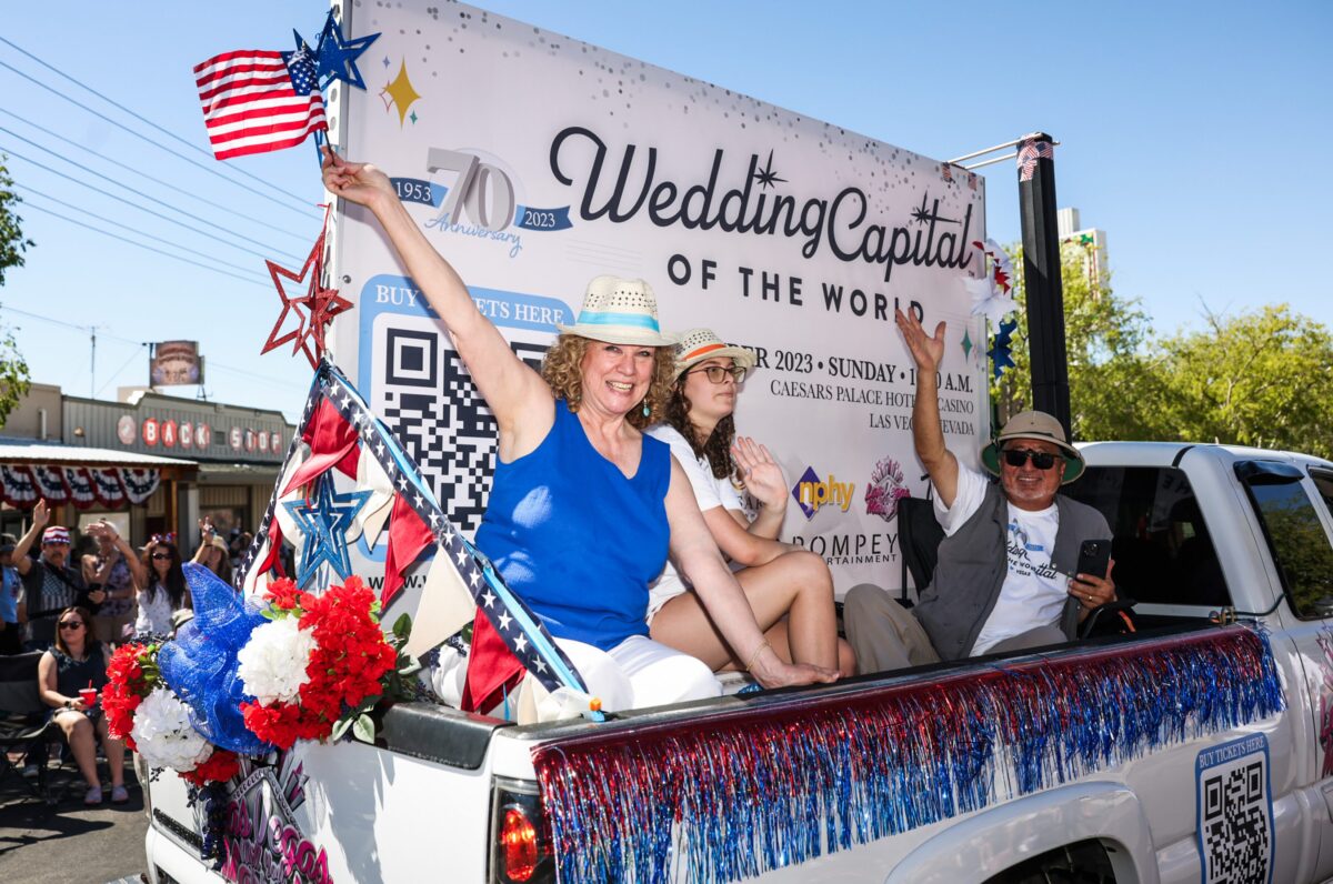 Clark County Clerk Lynn Goya, left, rides a float with her husband Alan Goya during the 75th Annual Damboree parade in Boulder City on Tuesday, July 4, 2023. (Jeff Scheid/The Nevada Independent)