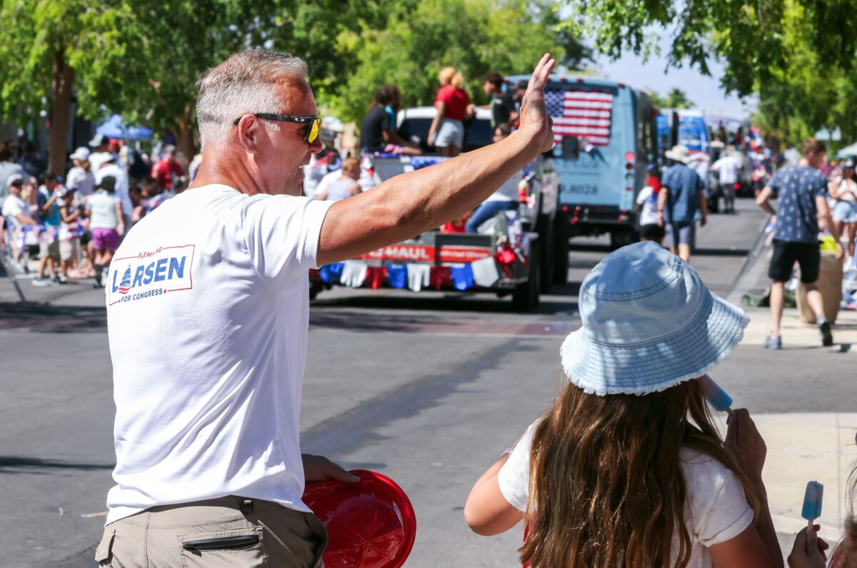 Flemming Larsen, Republican primary candidate for Nevada's 1st Congressional District, waves during the 75th annual Damboree parade in Boulder City on Tuesday, July 4, 2023. (Jeff Scheid/The Nevada Independent)