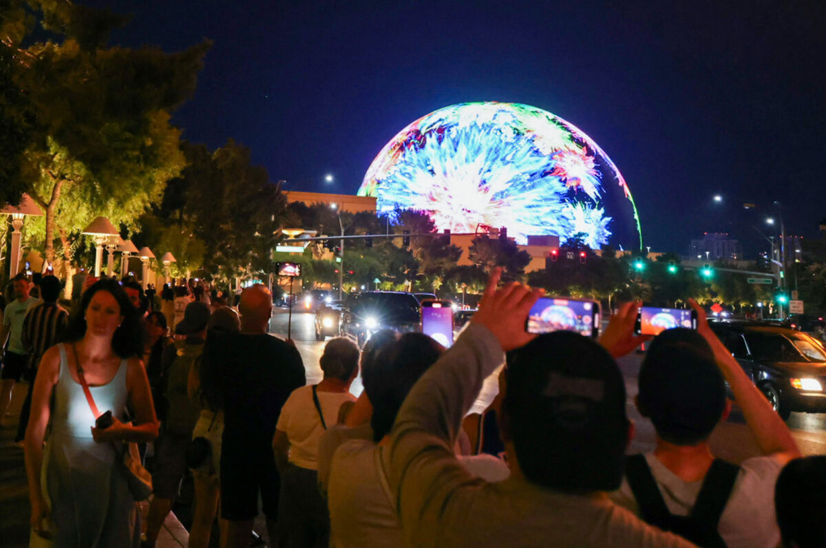 Strip visitors watch and photograph the Sphere in Las Vegas on July 4, 2023. (Jeff Scheid/The Nevada Independent)