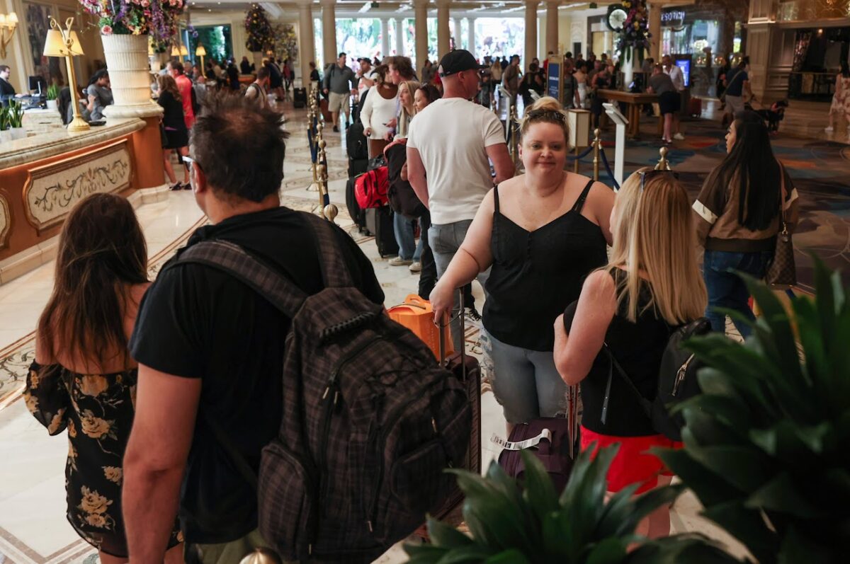 Guests stand in line at the front desk at Bellagio on Thursday, June 29, 2023. (Jeff Scheid/The Nevada Independent)