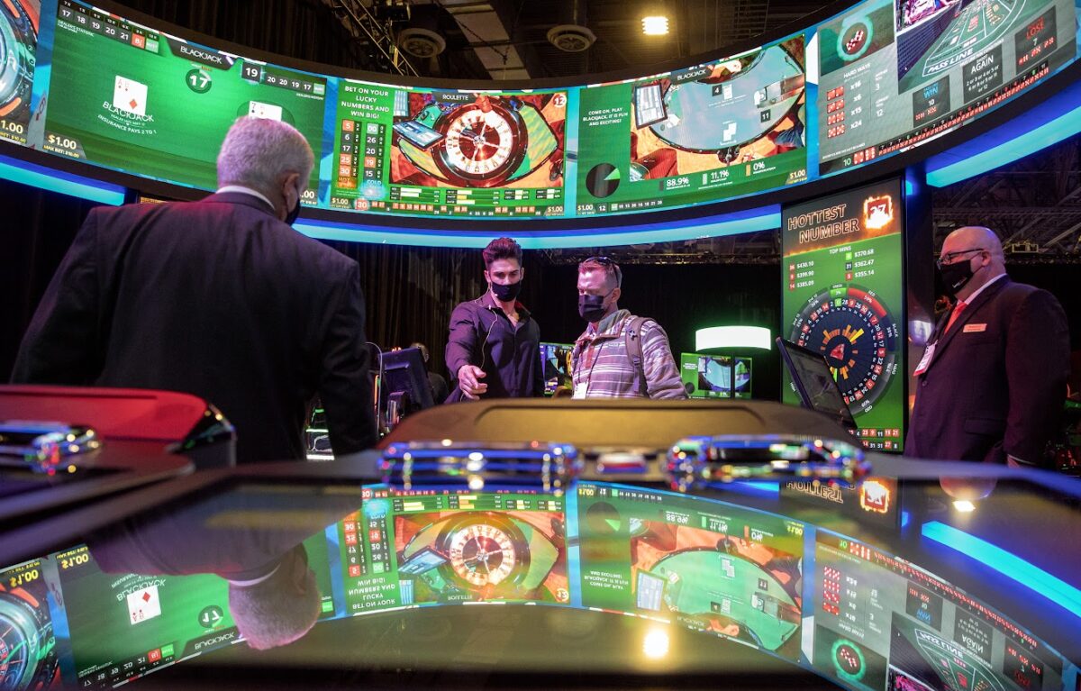 Global Gaming Expo attendees view the electronic table games at the Interblock booth on Tuesday, Oct. 5, 2021. (Jeff Scheid/The Nevada Independent) 