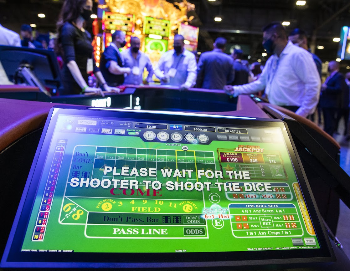 G2E attendees play Roll To Win Craps game at the Aruze Gaming booth on Tuesday, Oct. 5, 2021. (Jeff Scheid/The Nevada Independent)