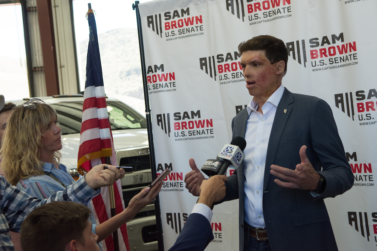 Sam Brown speaks to reporters after announcing a Republican bid for Senate at Bragg Crane Service in Sparks on July 10, 2023. (David Calvert/The Nevada Independent) .