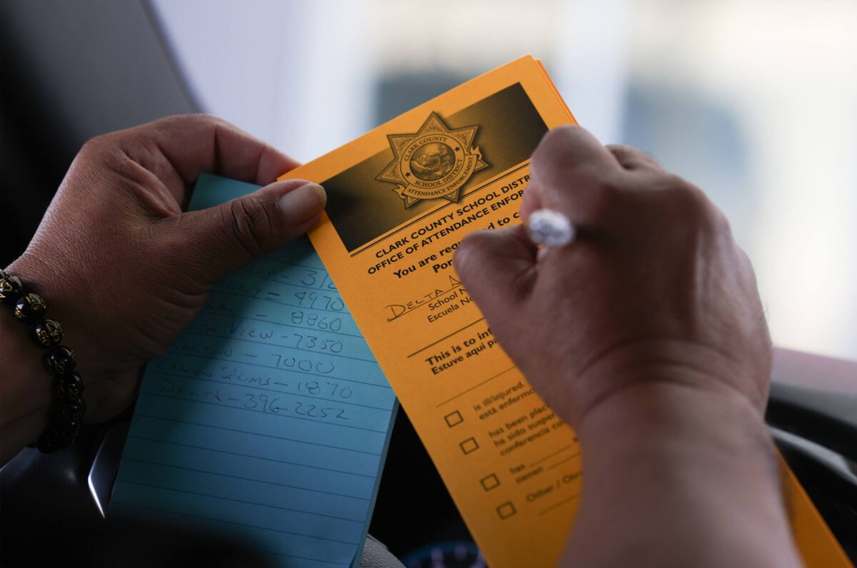 Clark County School District Attendance Officer Roberto Molina fills out a form regarding chronic student absenteeism.