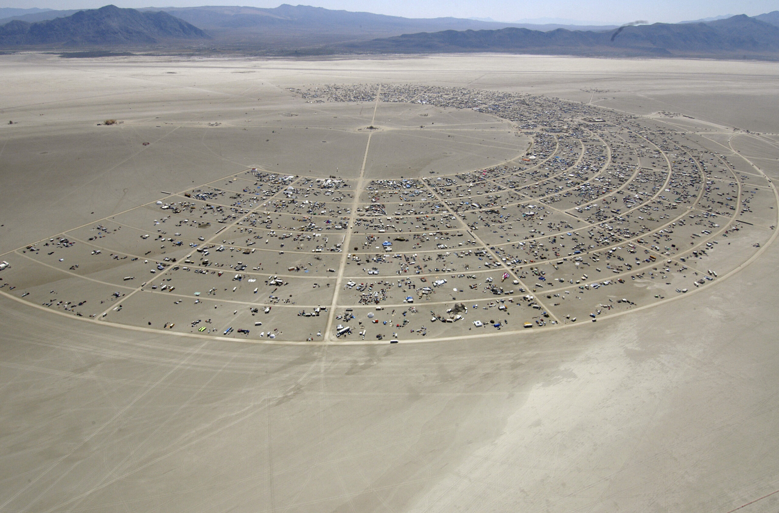 Black Rocky City begins to grow during the opening of Burning Man Sunday, Aug. 27, 2006, in Gerlach, Nev. Burning Man organizers don't foresee major changes in 2024 thanks to a hard-won passing grade for cleaning up this year's festival. Despite the successful inspection, debate continues over whether the 30-year-old gathering has grown too big. Some question whether it has veered too far from its core principles of radical inclusion and participation. (Ron Lewis. Associated Press)