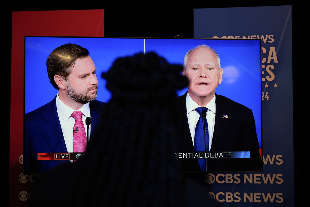 Viewers in the spin room watch the CBS News vice presidential debate.