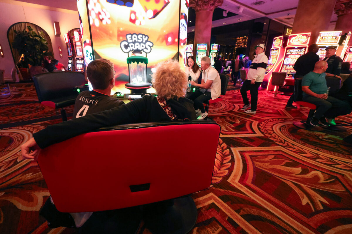 Gamblers play slot machines at Caesars Palace.