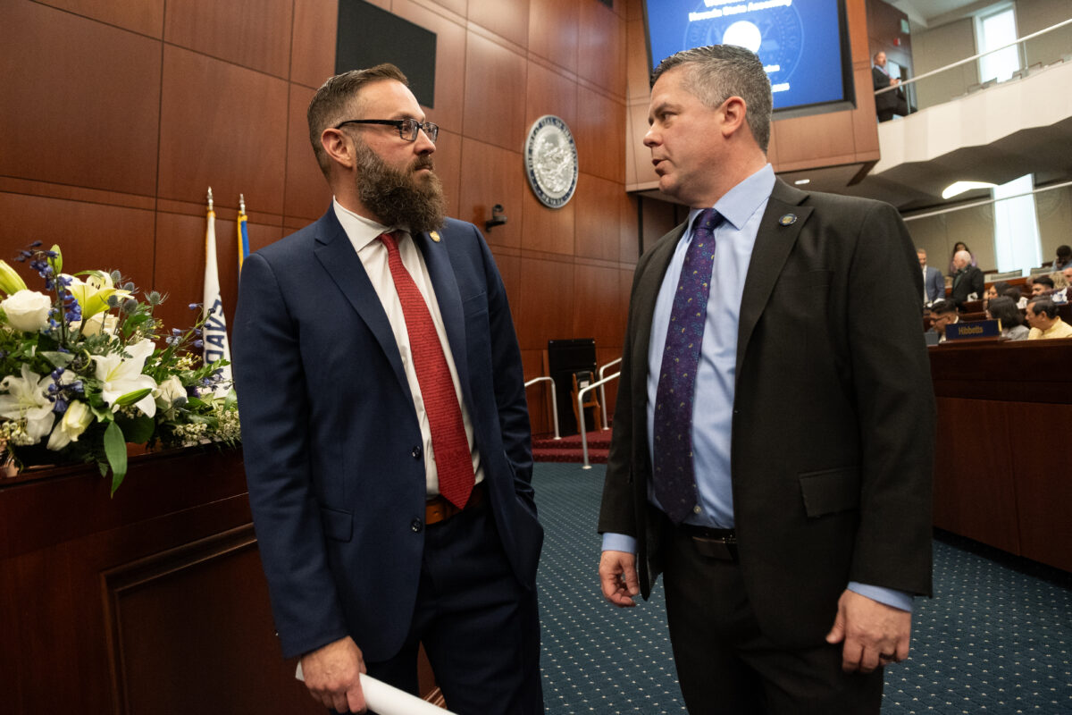 Assembly Minority Leader Gregory Hafen (R-Pahrump), left, and Speaker Steve Yeager (D-Las Vegas) stand next to each other as they talk.