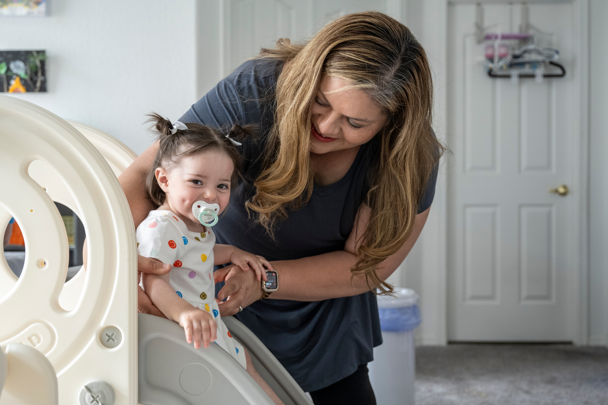 Patricia Orellana plays with her daughter Grace inside their Las Vegas home.