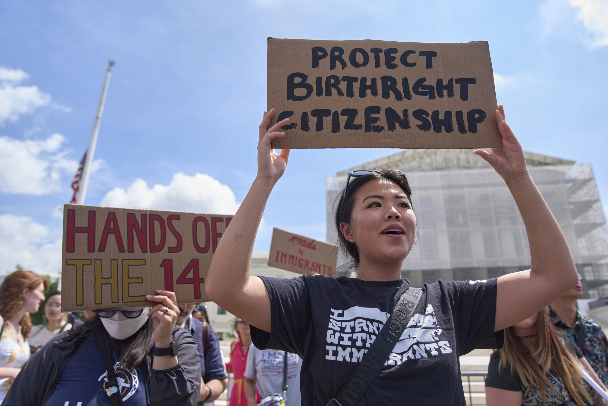 Hannah Liu, 26, of Washington, holds up a sign in support of birthright citizenship on May 15, 2025, outside of the Supreme Court in Washington, D.C.