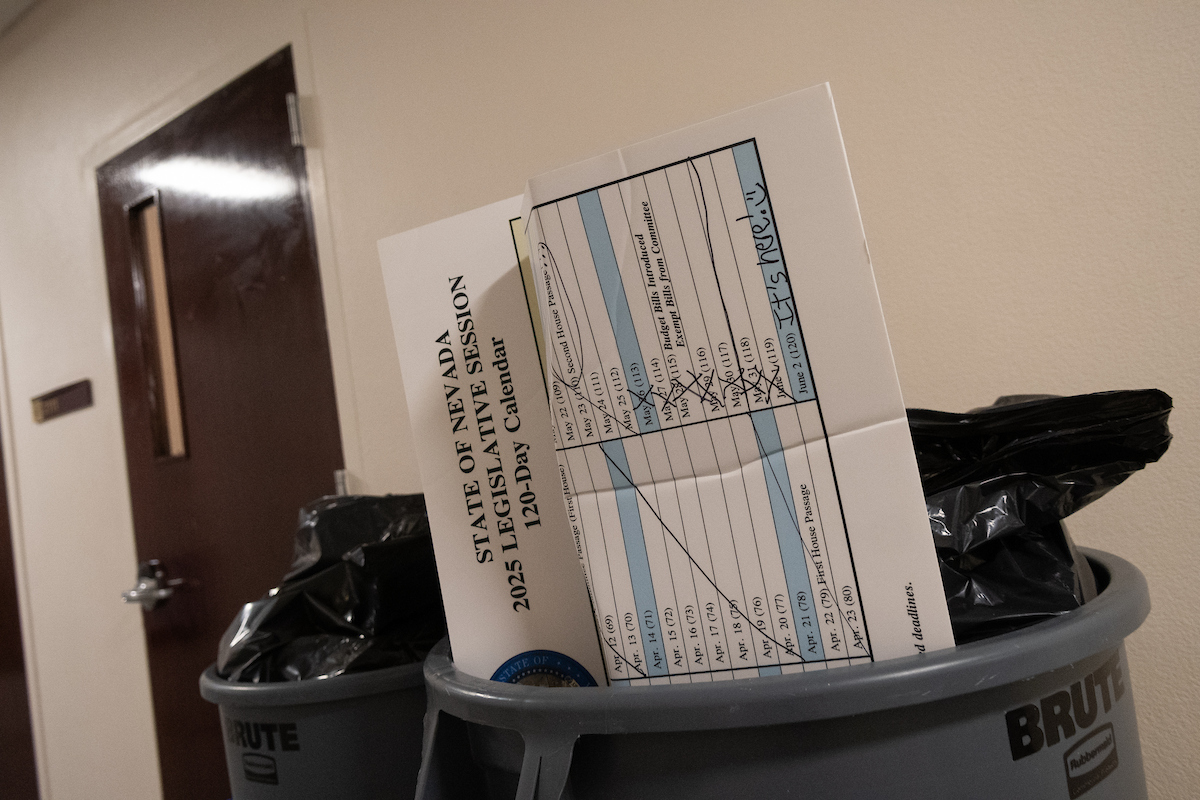 A poster board with the 120-day legislative calendar in a trash can inside the Legislature.
