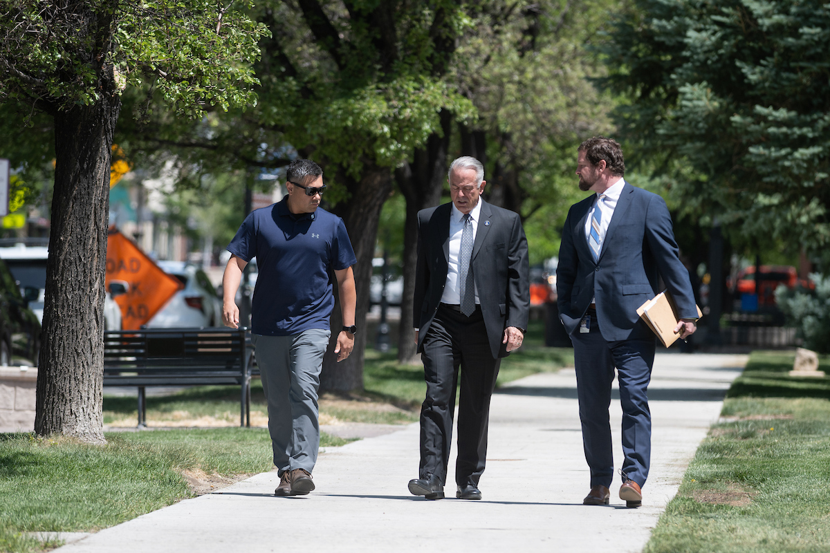 Gov. Joe Lombardo, center, walks with a member of his protective detail, left, and his Chief of Staff Ryan Cherry, right, on their way to the Legislature.