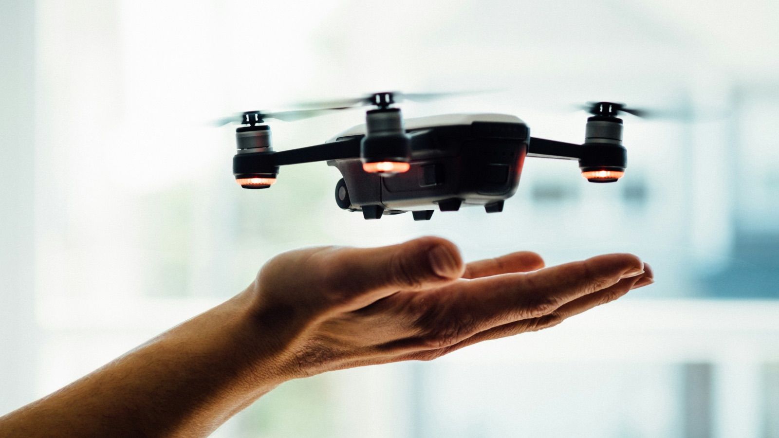 Someone's hands opened up letting a drone take off from them
