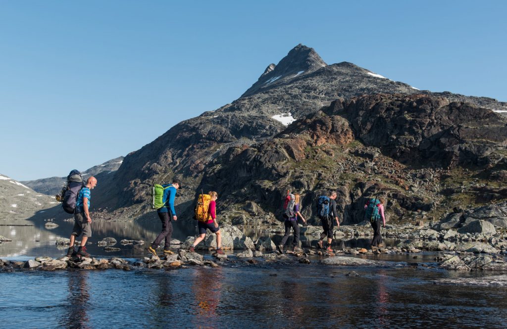 Crossing a river the peak Uranostind in the background – Yngve Ask
