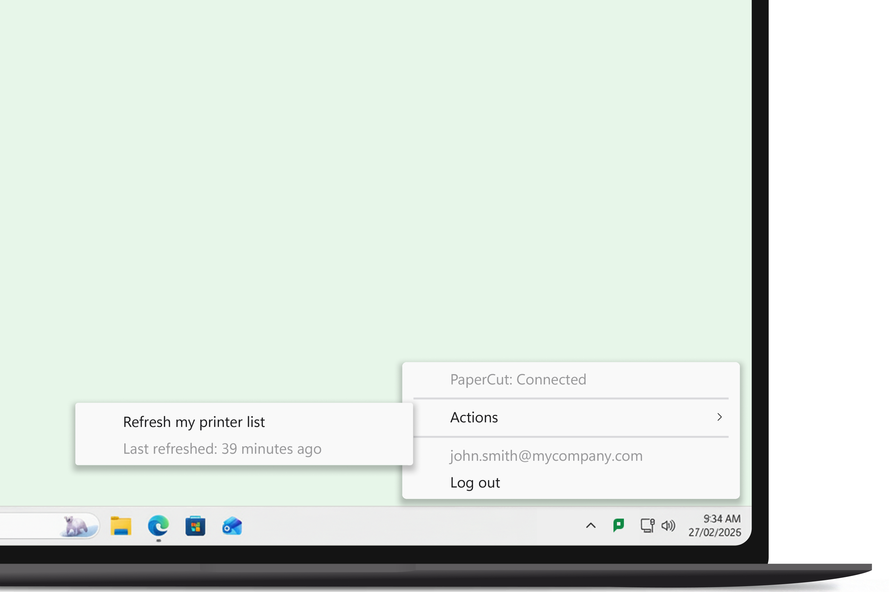 An image of a laptop, showing the desktop, and the PaperCut Hive system tray app open.