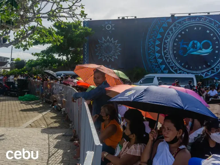 People carrying umbrellas while under the heat of the sun