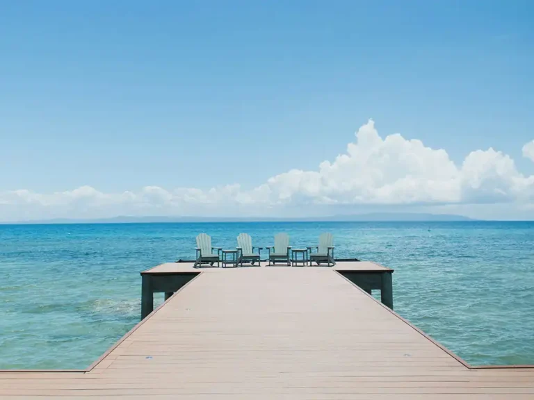 Four tanning chairs at the edge of cliff for some Bleisure Travel activities