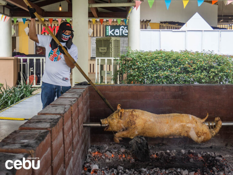 A man roasting a Cebu Lechon