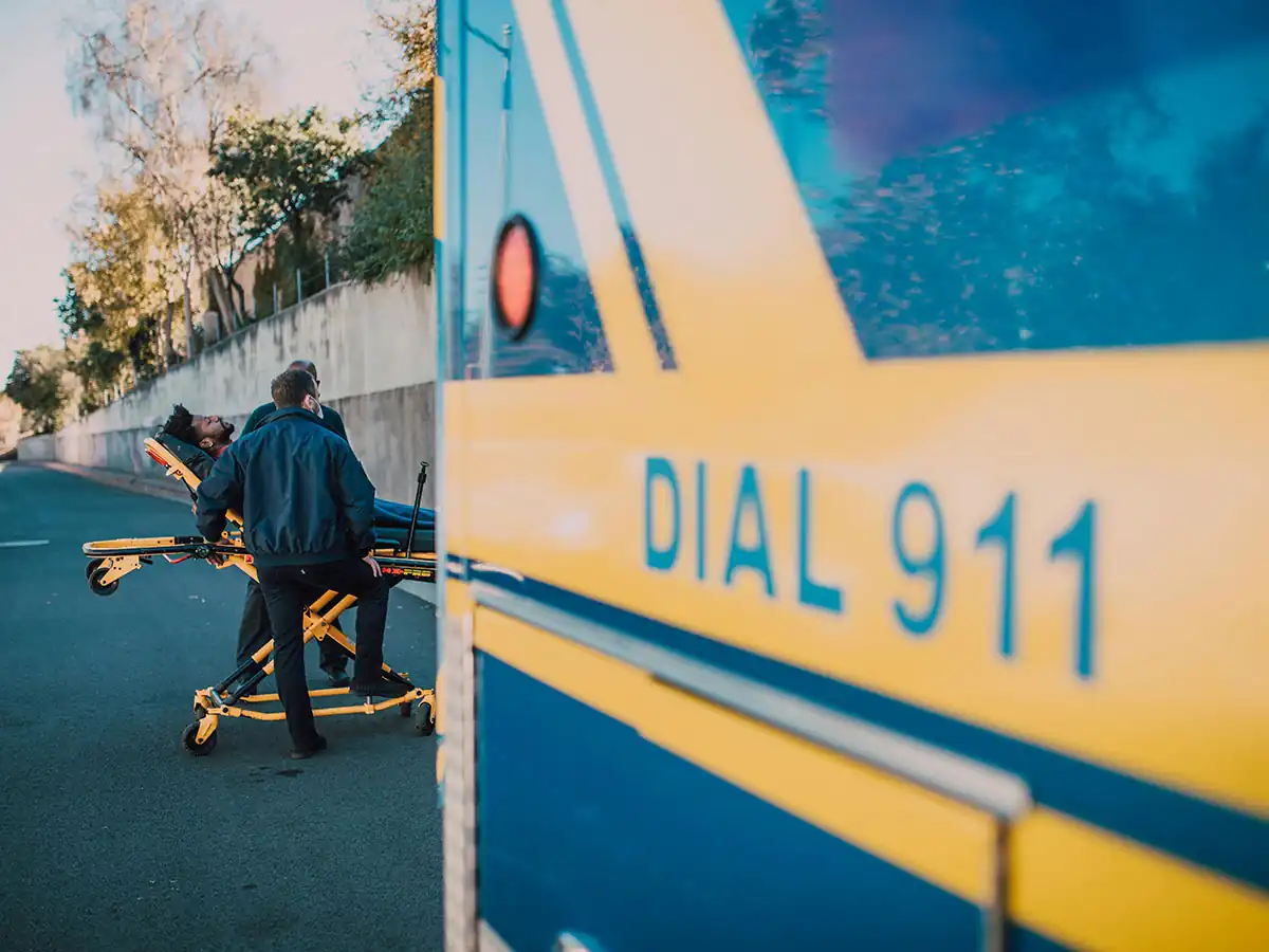 Man being carried by 911 Paramedics
