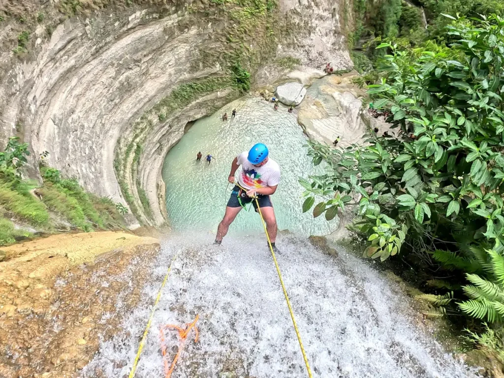 a man rappelling down the Dao Falls, Cebu
