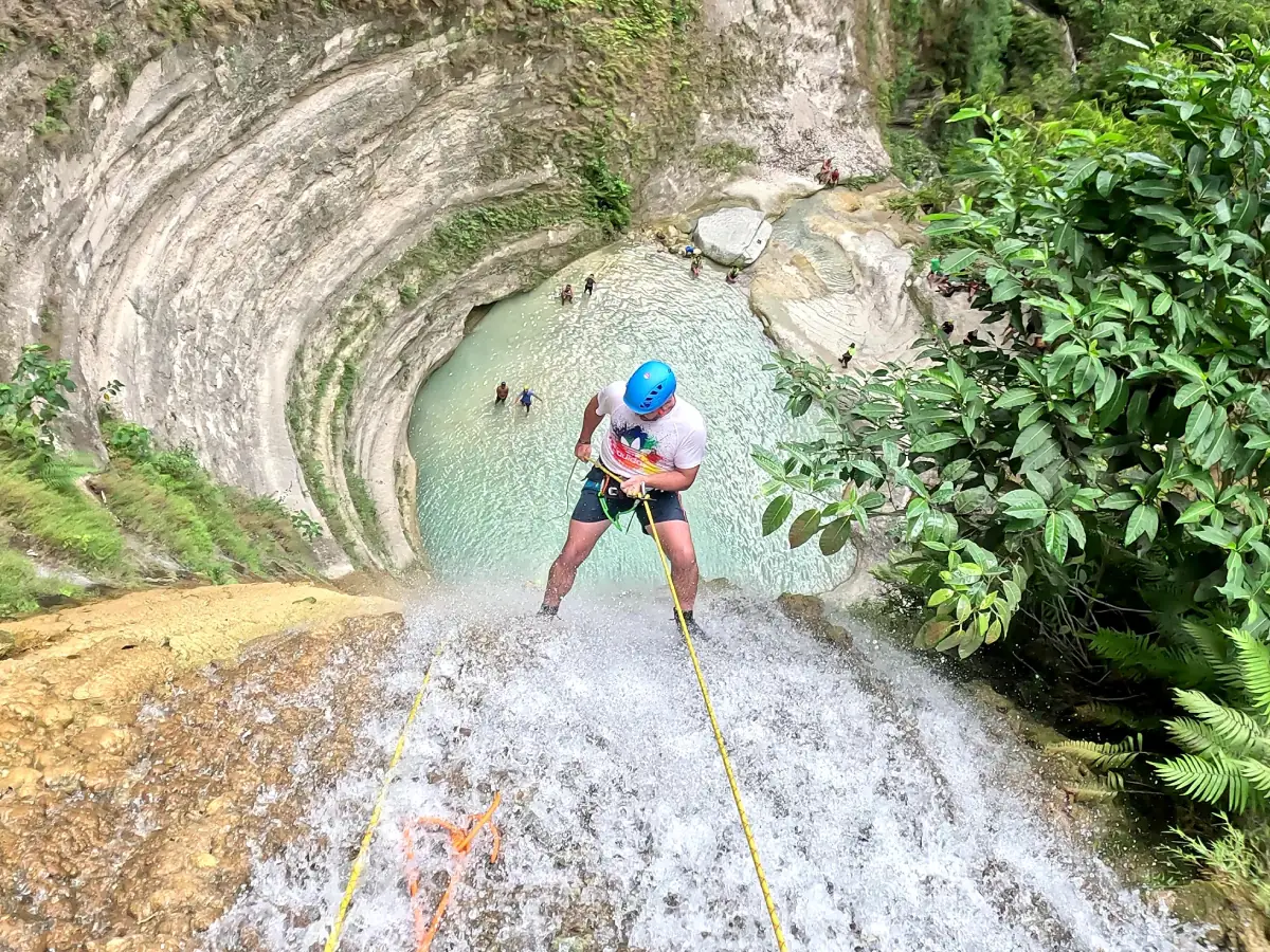 dao-falls-canyoneering a man rappelling down the Dao Falls, Cebu