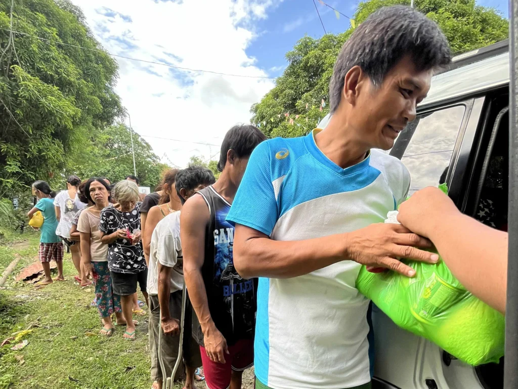 Victims receiving aid from donors during the Cebu earthquake aftermath