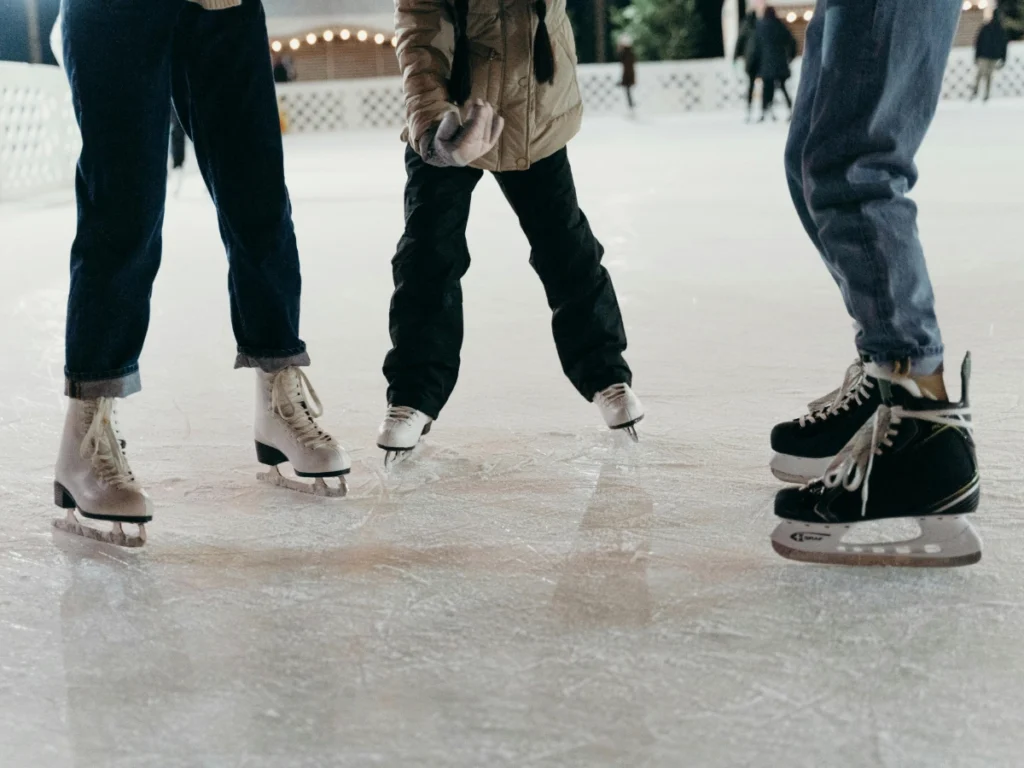 Three people at an ice skating rink, to highlight the SM Seaside Ice Skating Rink