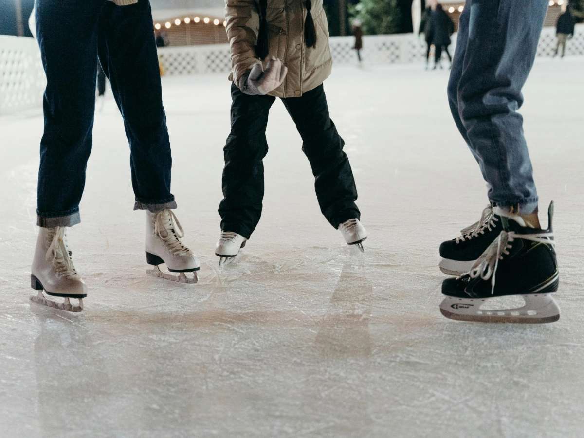 Three people at an ice skating rink, to highlight the SM Seaside Ice Skating Rink