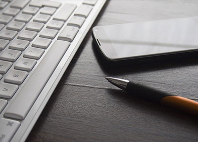 desktop-accounting person typing numbers into a calculator