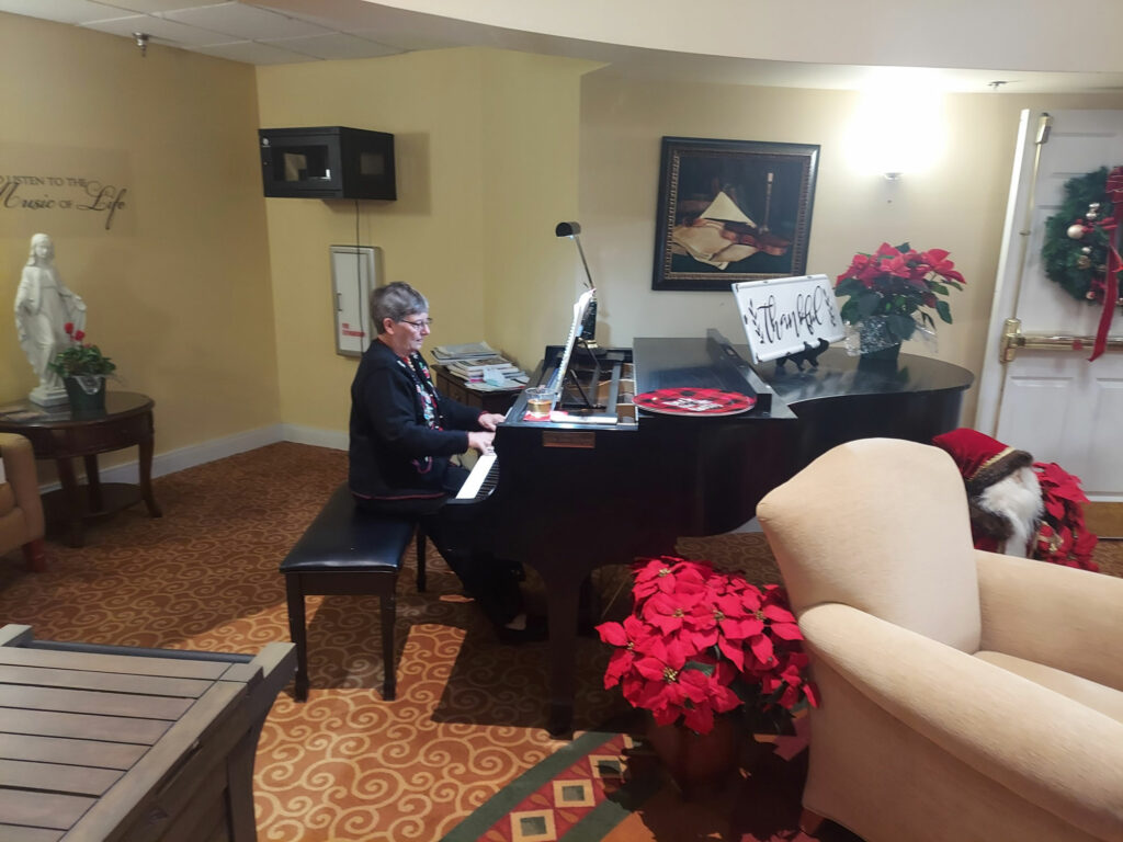 musician playing holiday songs on a grand piano