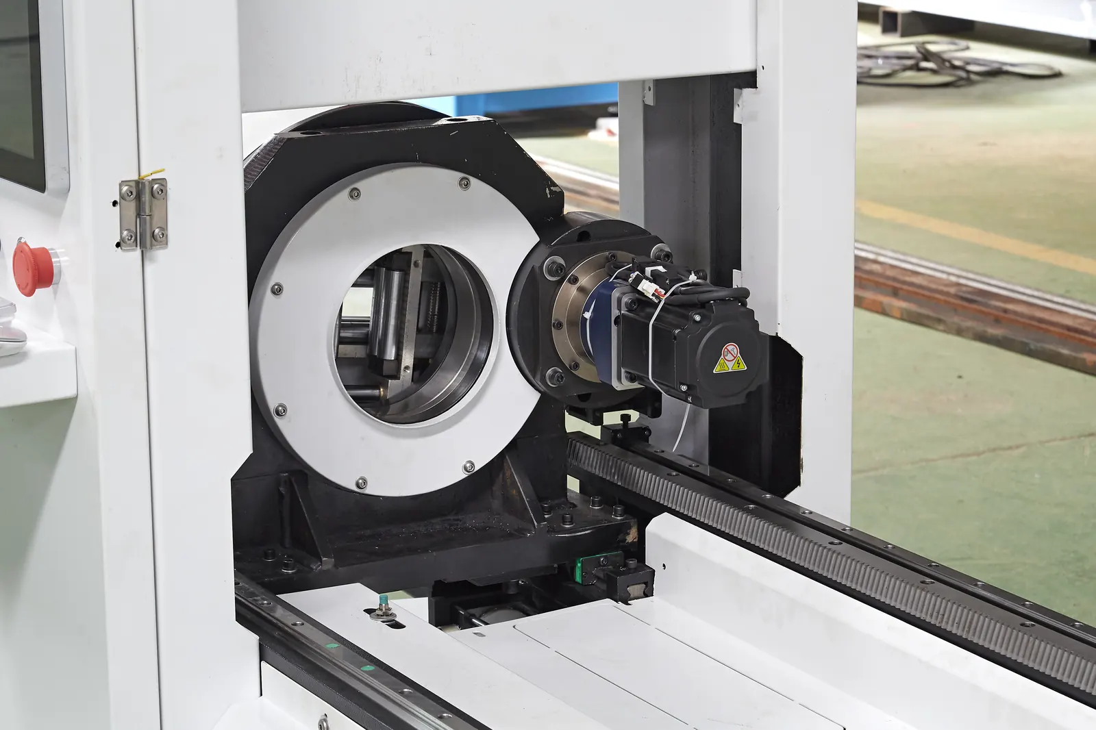 Fiber laser cutting head over a BNL chuck mid-cut