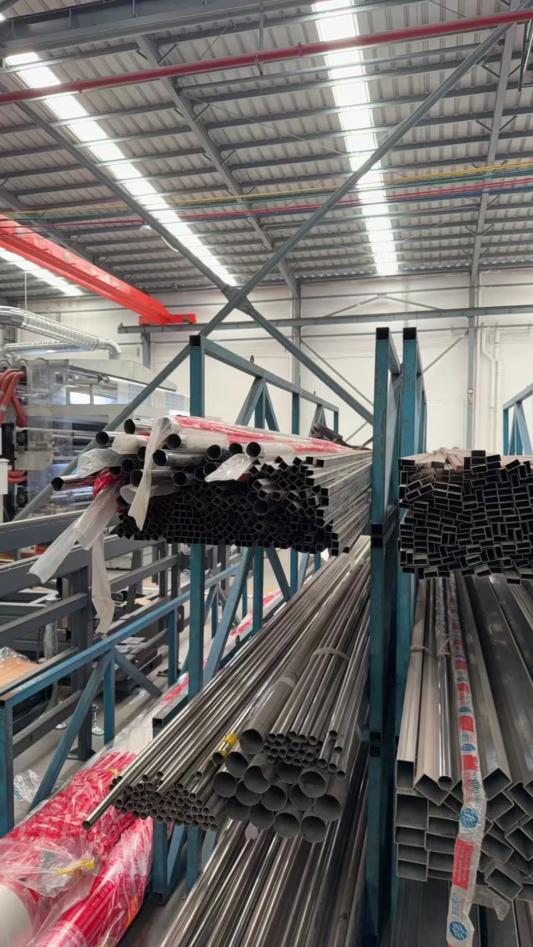 Round and rectangular metal tube ends on a workshop storage rack