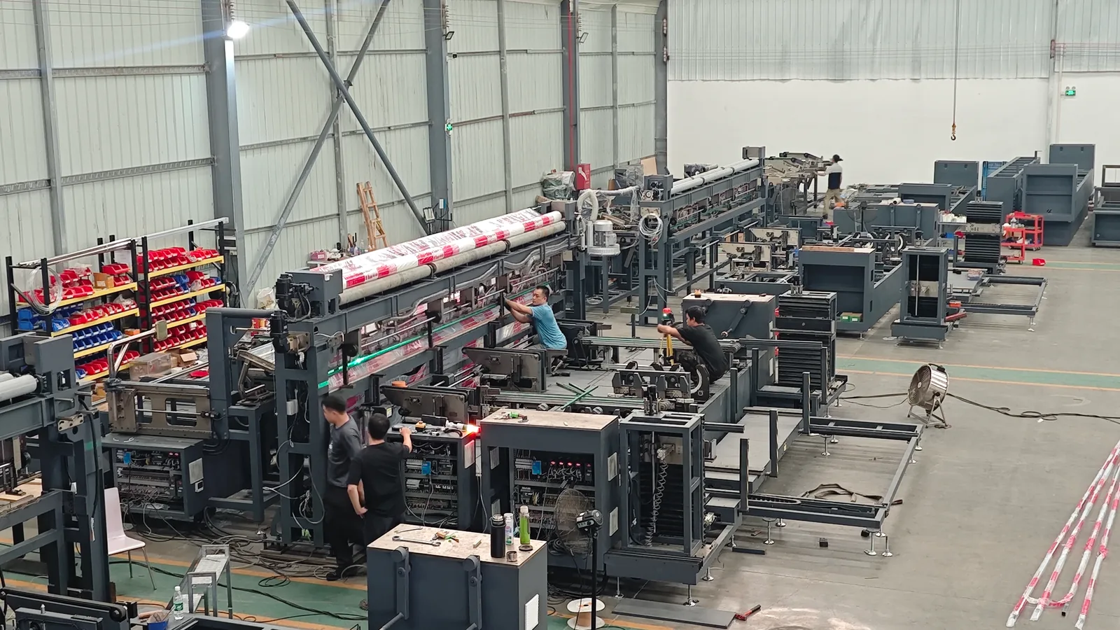 Wide view of packaging equipment arranged inside the workshop