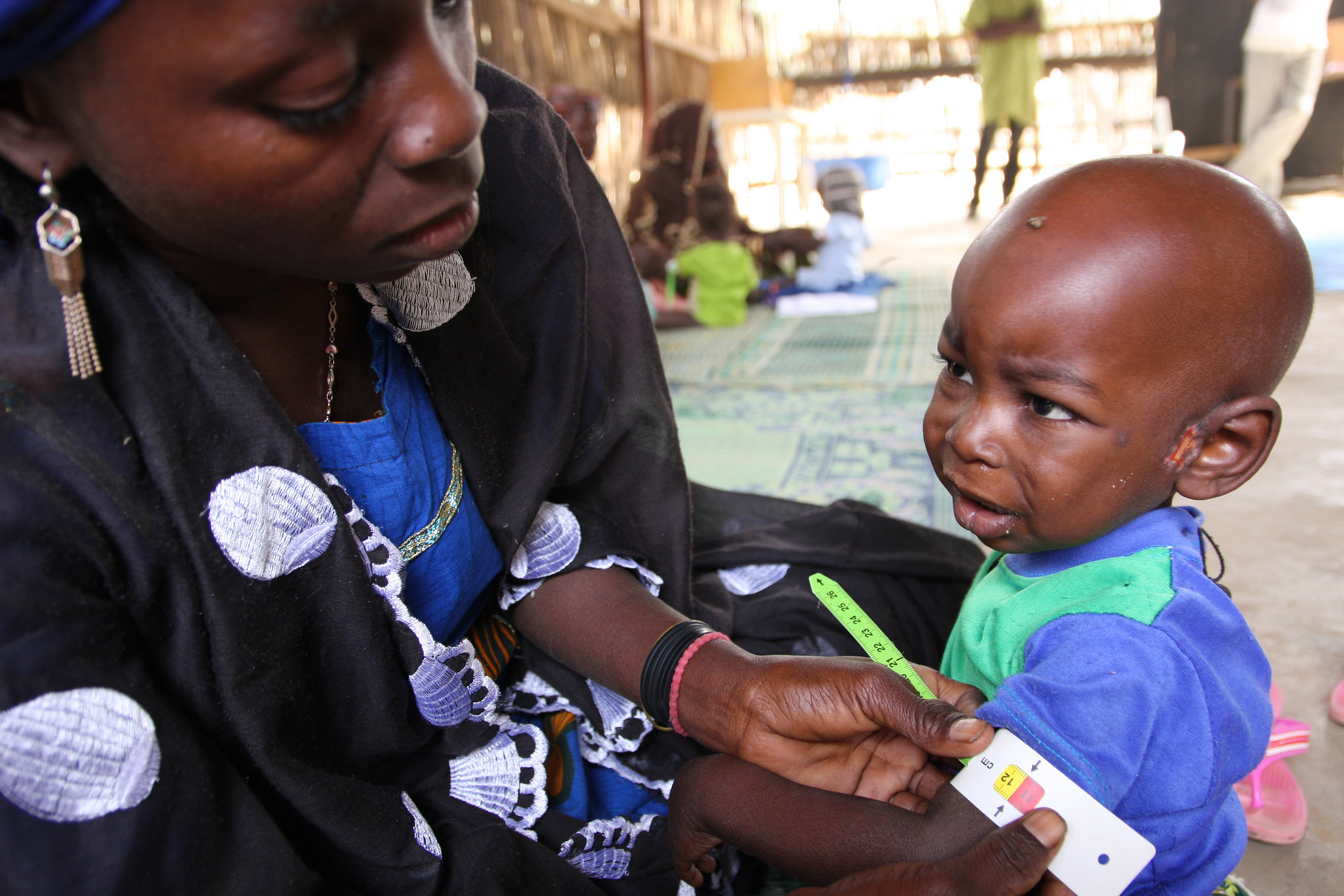 A woman in Niger measures her baby's arm circumference—part of a program that teaches mothers to regularly monitor for signs of malnutrition. Such integrated nutrition interventions can play a key role in improving overall public health, according to IFPRI Senior Research Fellow Harold Alderman.