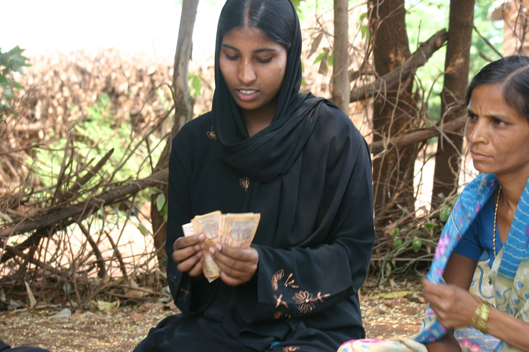 A woman counting money at a Self Help Group Meeting in Bidar, Karnataka