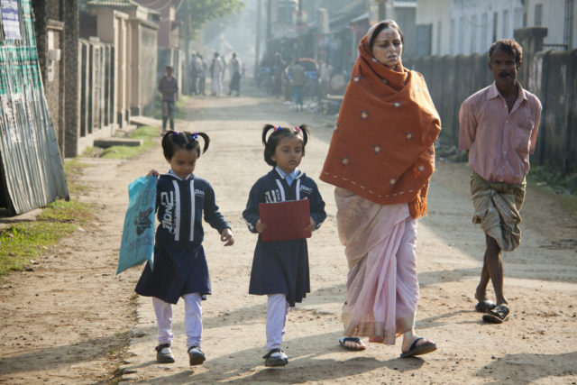 Children going to school with their mother