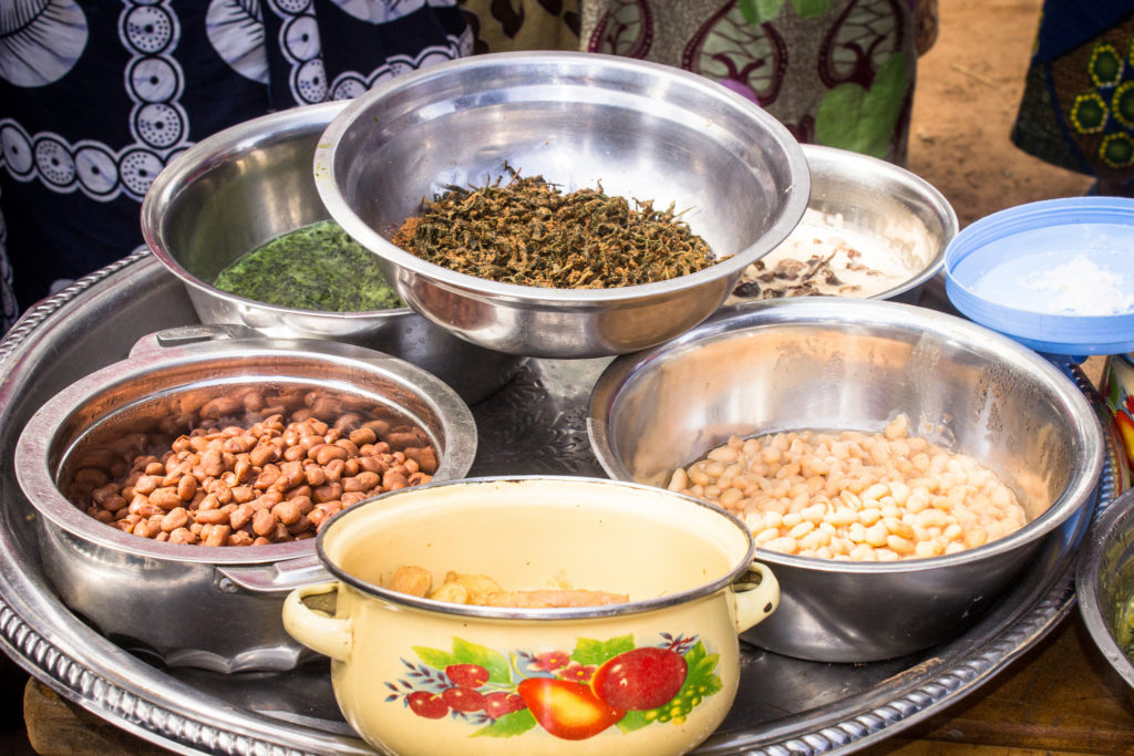 Women display foraged and cultivated forest foods at a food fair in Luwingu, Zambia