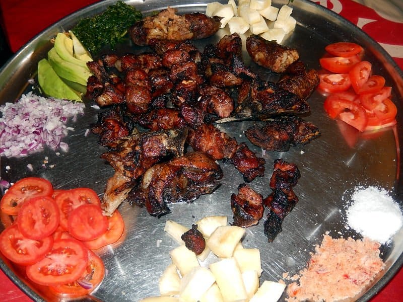 A plate served with fried pork and raw relishes (photo credit: ILRI/Martin Heilmann, Freie Universitaet Berlin).