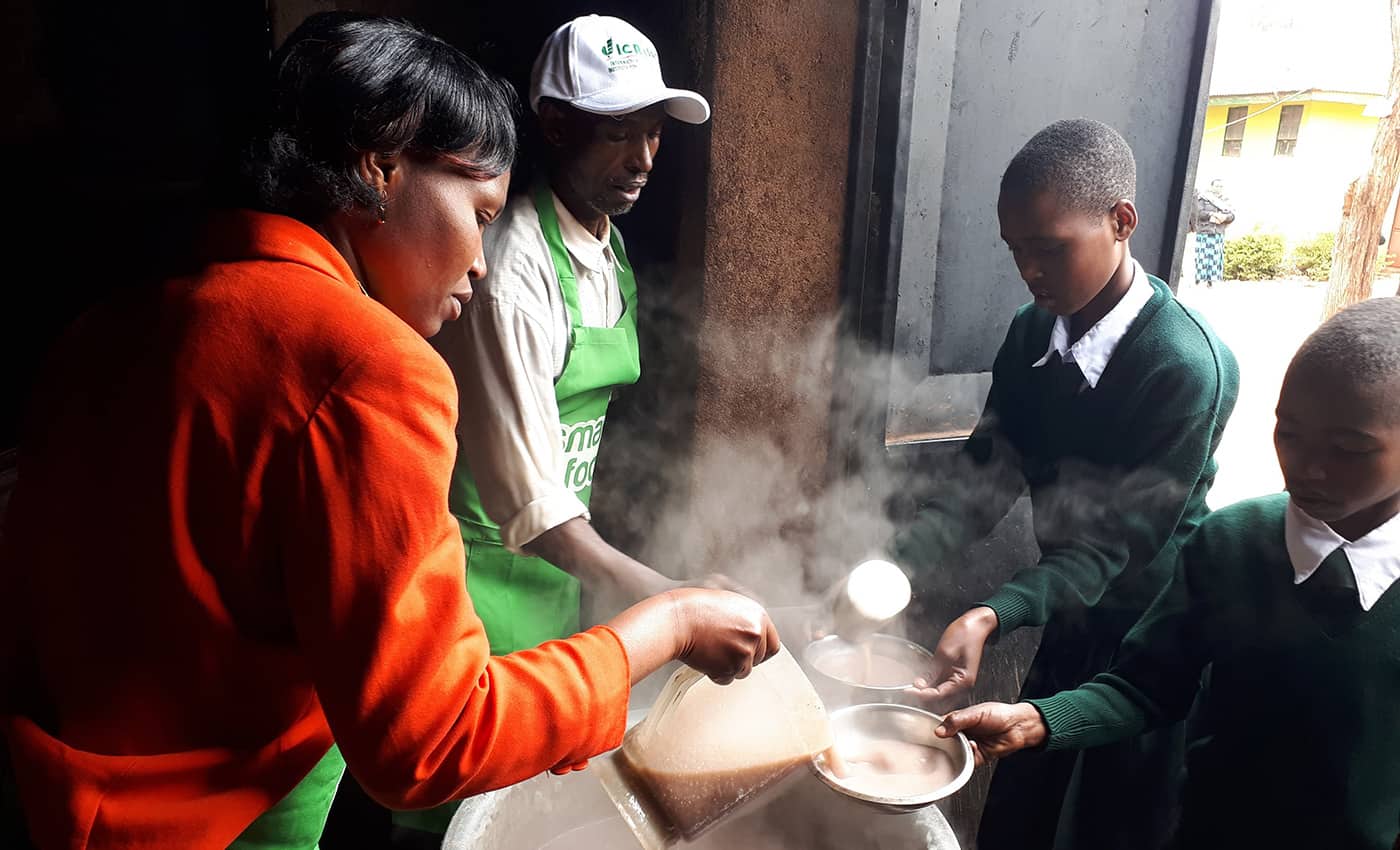 Children in Tanzania being served finger millet porridge as part of the Smart Food initiative in Africa