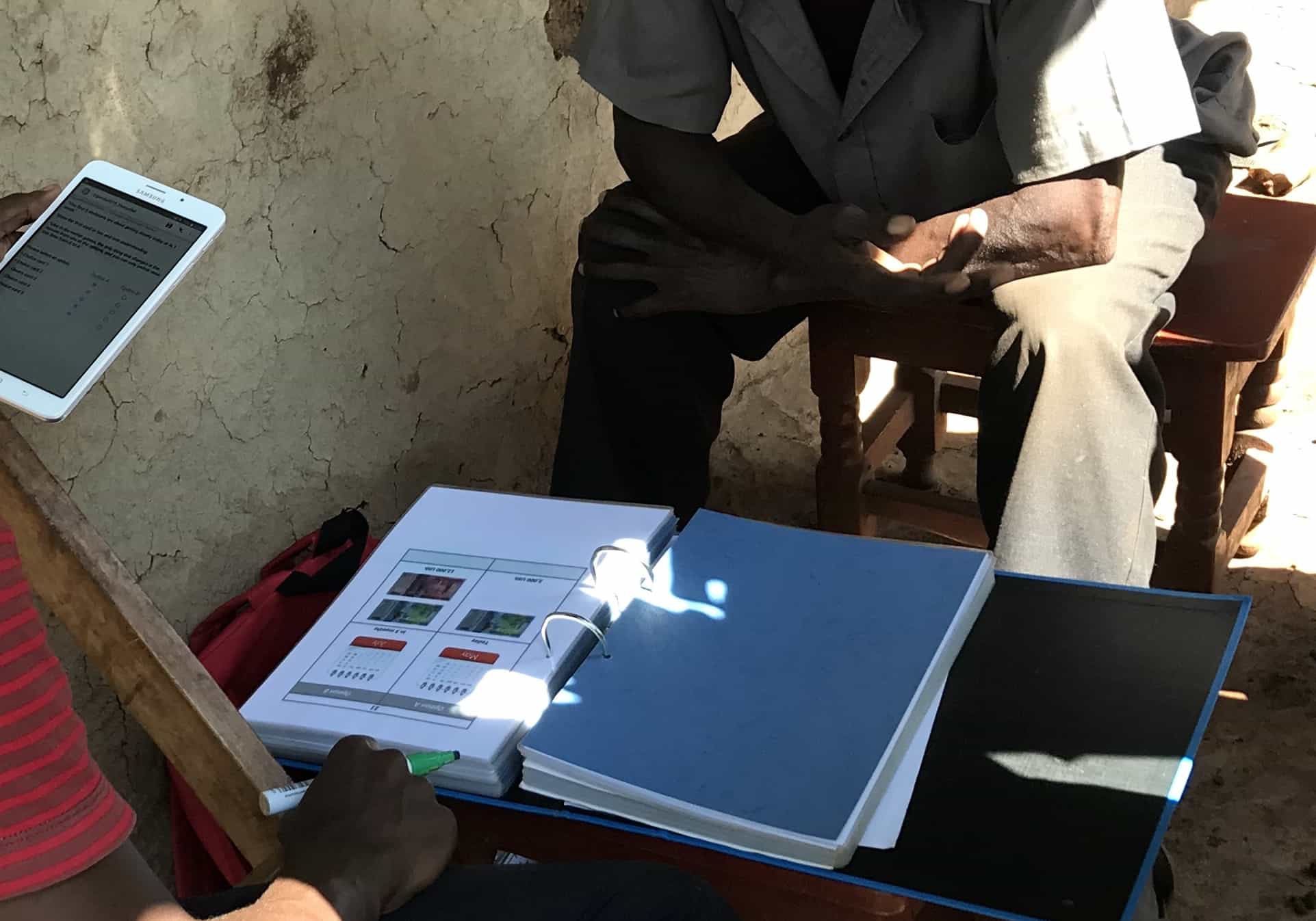 An enumerator guides a farmer through the research experiments in Kapchorwa District, Mount Elgon region, eastern Uganda. Photo: World Agroforestry