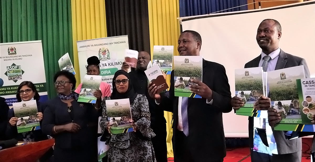 The Honorable Minister and other cassava stakeholders displaying the National Cassava Development Strategy book.