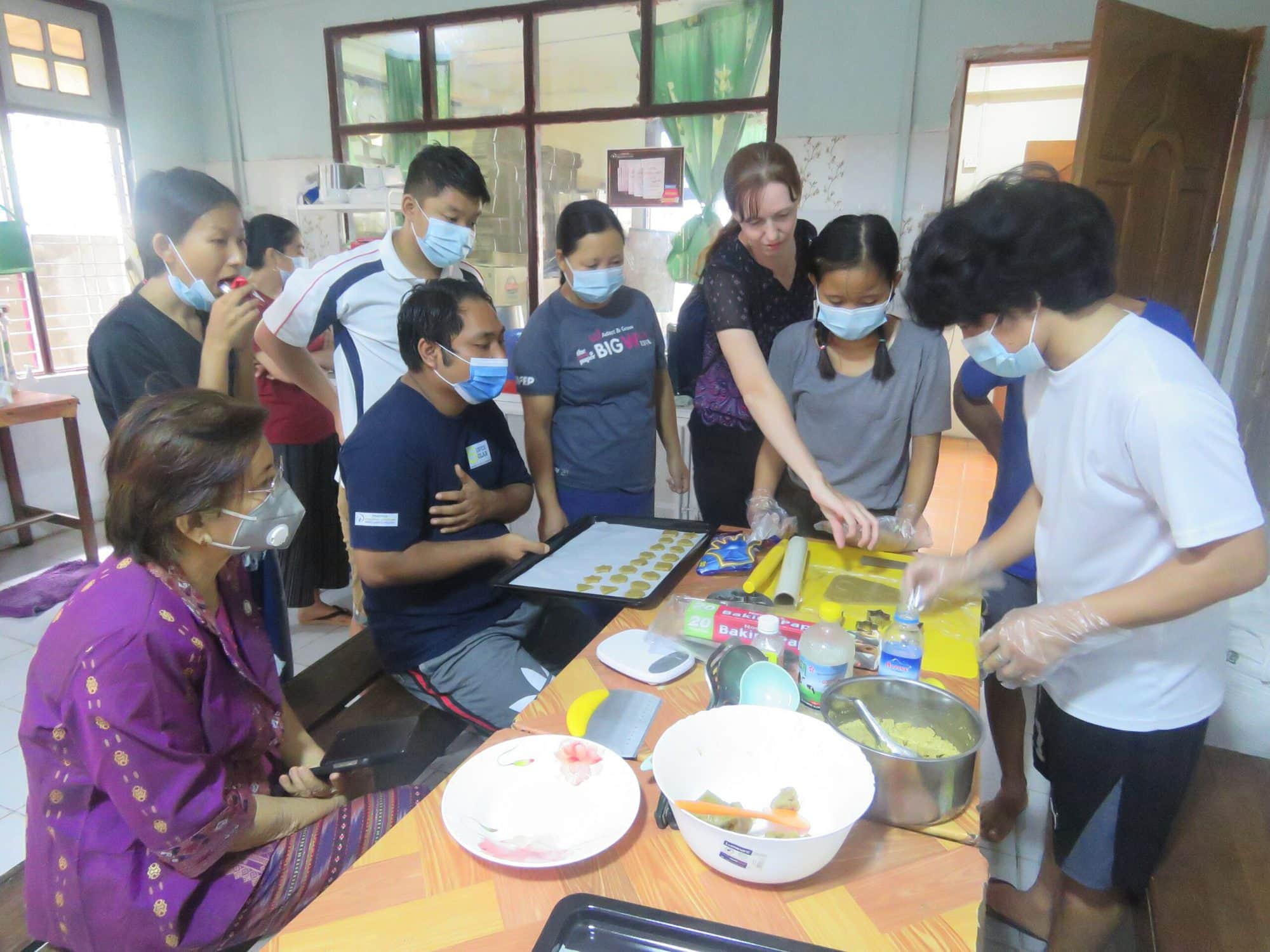 Youth prepare nutritious biscuits using FedWell’s dried small fish powder. Photo by Thomas Tha Thaw.