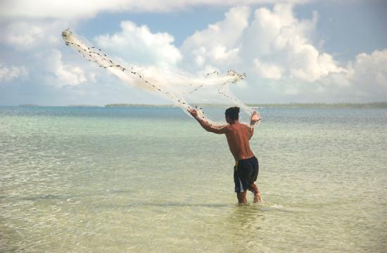 A fisherman casts his net in the Republic of Kiribati. Photo by Quentin Hanich