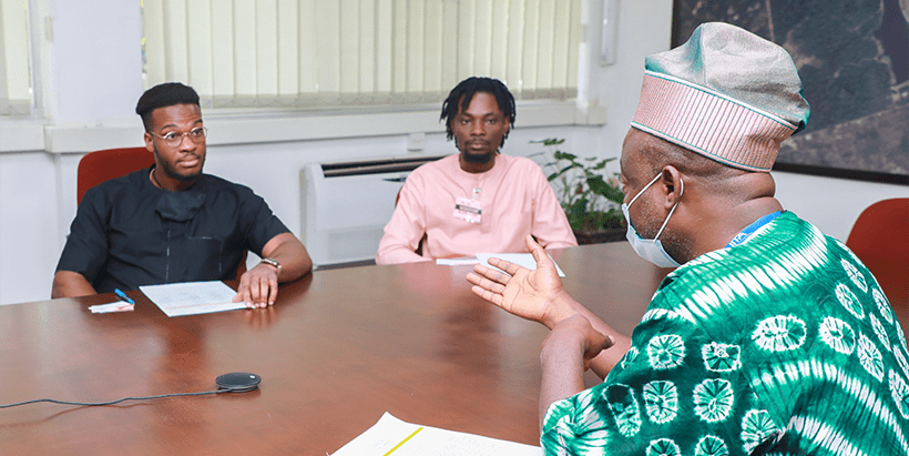 Prof. Sanni (right) speaking with the Releaf team, led by Ikenna Nzewi (left).